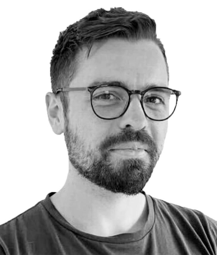 James Speyer A black and white headshot of a mean with a beard and glasses.